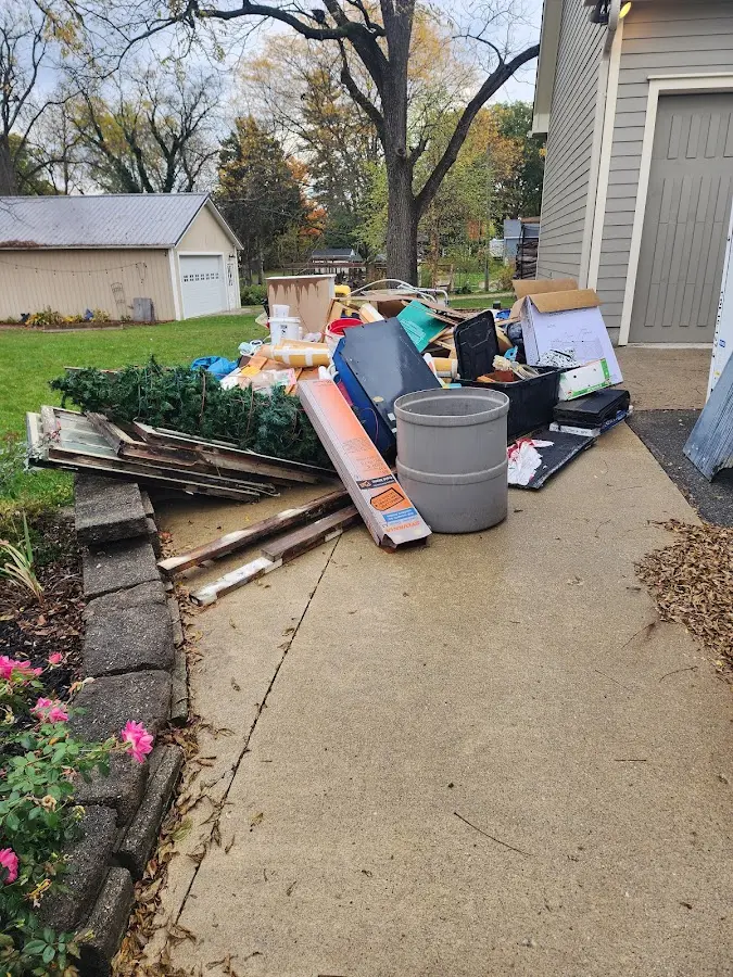 Dumpster being loaded with debris for 12 Yard Dumpster Rental in Ozark
